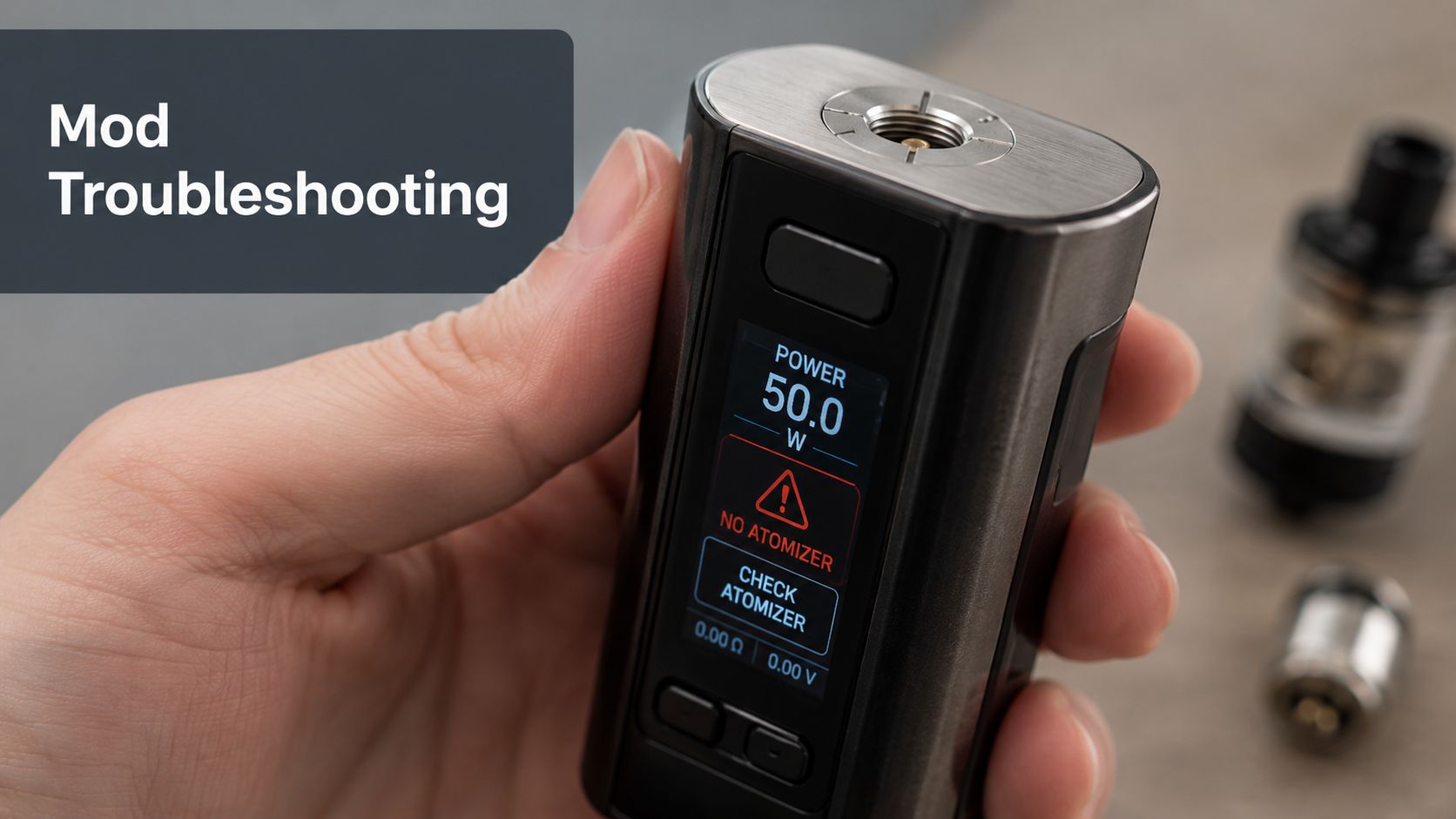A hand holding a metallic vape mod displaying a No Atomizer error message on its screen.