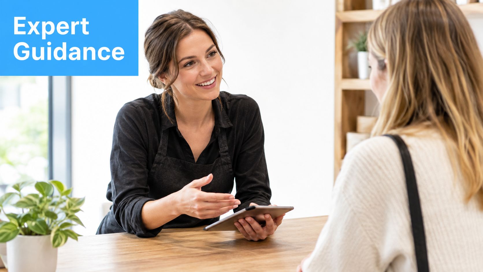 A smiling customer service representative providing expert guidance and advice to a client using a digital tablet.